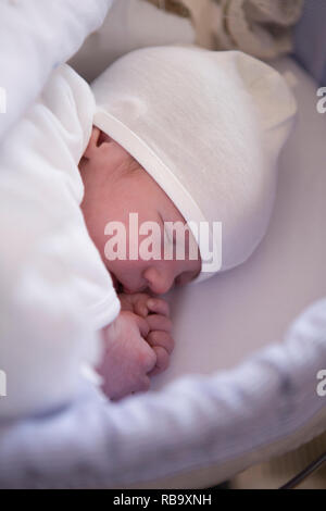 Sleeping few day-old baby newborn. Overheating newborn concept Stock Photo