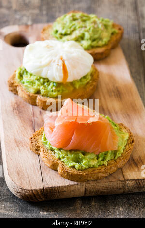 Toasted breads with poached eggs, avocado and salmon. Close up Stock Photo