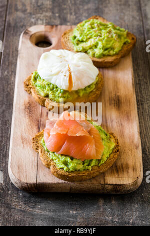 Toasted breads with poached eggs, avocado and salmon. Close up Stock Photo