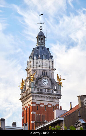 Clock tower in Saint-Gilles municipality. Close-up shot. Cloudy sky on background. Brussels, Belgium Stock Photo