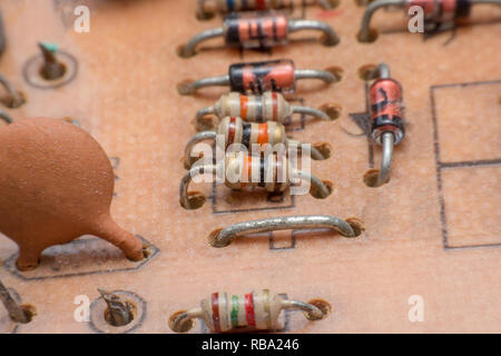 Close up electronic hardware Resistor and condensers assembly on the circuit board Stock Photo