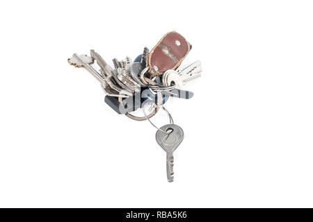 Many old keys on a ring with a torn keychain isolated on white background Stock Photo