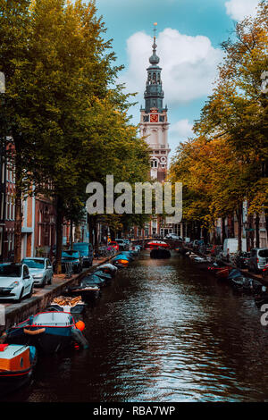 Amazing Groenburgwal canal in Amsterdam with the Soutern church Zuiderkerk at sunset in autumn Stock Photo