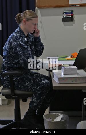 U.S. Navy Petty Officer 1st Class Tara Goodell, Joint Task Force - National Capital Region (JTF-NCR), coordinates special events logistics for the 58th Presidential Inauguration in Washington, D.C., Jan. 4, 2017. The JTF-NCR is a joint service command that coordinates all military ceremonial support for the Inauguration. It includes members from all branches of the armed forces of the United States. Stock Photo