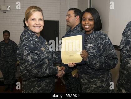 NEWPORT NEWS, Va. (Jan. 04, 2017) – Logistics Specialist 2nd Class Darcy Stanford, assigned to Pre-Commissioning Unit Gerald R. Ford (CVN 78), is announced as the Supply Department Petty Officer of the Quarter by Cmdr. Julie Treanor, Ford’s supply officer, and Ford’s command master chief Laura Nunley CVN 78 Command Master Chief, during an awards and quarters ceremony at Apprenticeship Hall. Stock Photo