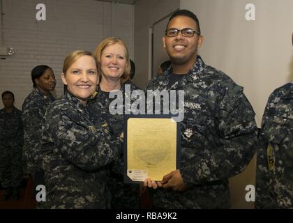 NEWPORT NEWS, Va. (Jan. 04, 2017) – Logistics Specialist 3rd Class Kevin Allen, assigned to Pre-Commissioning Unit Gerald R. Ford (CVN 78), is announced as the Supply Department Junior Petty Officer of the Quarter by Cmdr. Julie Treanor, Ford’s supply officer, and Ford’s command master chief Laura Nunley CVN 78 Command Master Chief, during an awards and quarters ceremony at Apprenticeship Hall. Stock Photo