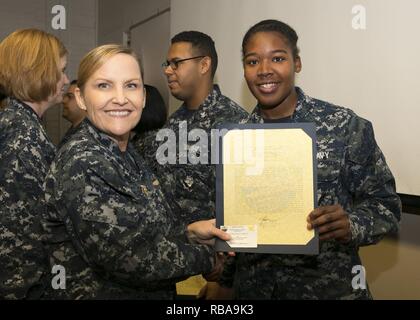 NEWPORT NEWS, Va. (Jan. 04, 2017) – Ship’s Serviceman Seaman Shangarcia Tennant, assigned to Pre-Commissioning Unit Gerald R. Ford (CVN 78), is announced as the Supply Department Bluejacket of the Quarter by Cmdr. Julie Treanor, Ford’s supply officer, and Ford’s command master chief Laura Nunley during an awards and quarters ceremony at Apprenticeship Hall. Stock Photo