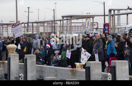 NORFOLK, Va. (Dec. 16, 2018) Families and friends of Sailors assigned to the Arleigh Burke-class guided-missile destroyer USS Arleigh Burke (DDG 51) wait on the pier while the ship returns to homeport. Arleigh Burke returns to Naval Station Norfolk following the Harry S. Truman Carrier Strike Group's (HSTCSG) deployment in support of maritime security operations and theater security cooperation efforts in the U.S. 2nd, 5th and 6th fleet areas of responsibility. Stock Photo