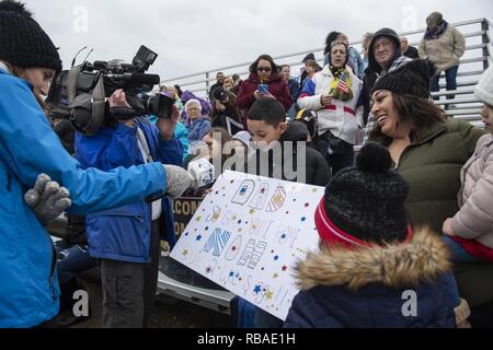 NORFOLK, Va. (Dec. 16, 2018) Julian Henegar and family speak with local media while awaiting the arrival of the Nimitz-class aircraft carrier USS Harry S. Truman (CVN 75) to homeport. Truman returns to Naval Station Norfolk following the Harry S. Truman Carrier Strike Group’s (HSTCSG) deployment in support of maritime security operations and theater security cooperation efforts in the U.S. 2nd, 5th and 6th Fleet areas of responsibility. Stock Photo