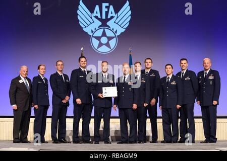 Gen. Jay Raymond, Air Force Space Command commander (right), and Lt. Col. Kevin Amsden, 3rd Space Experimentation Squadron commander (center), gather at the 2018 Air, Space & Cyber Conference in National Harbor, Maryland, Sept. 17, 2018. The Air Force Association presented the squadron with the 2018 Best Space Operations Crew award, which recognizes the top overall space operations crew in the United States Air Force. Stock Photo