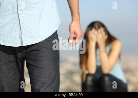 Sad woman complaining outdoors after break up. Boyfriend leaving her Stock Photo