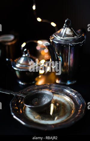 silver dishes on a black background - vintage Stock Photo