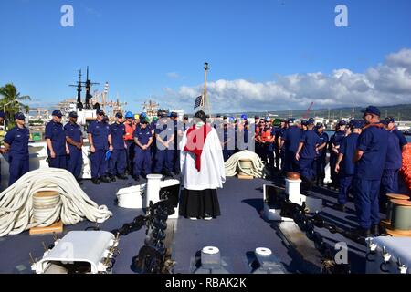 Rev. Malcolm Chun blesses CGC Kimball (WMSL 756) and its crew after it arrived at its new homeport of Honolulu Dec. 22, 2018. Kimball is the first National Security Cutter to be based in Hawaii. Stock Photo