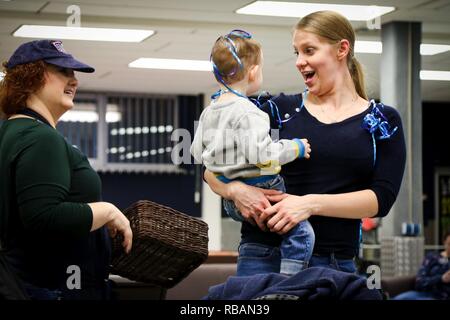 Clark, the Chicago Cubs mascot, signs a hat for a fan at the USO at USAG  Bavaria in Grafenwoehr, Germany, Dec. 11, 2018. The USO sponsored a Chicago  Cubs mascot tour of