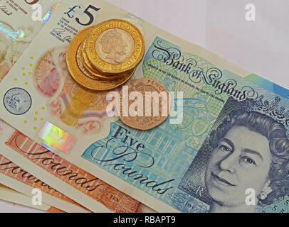 Bank Of England plastic £5 £10 Five pound and ten pound bank notes, with coins Stock Photo