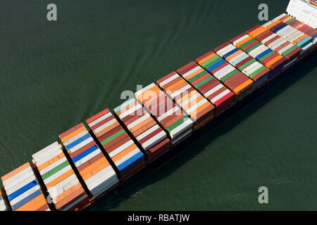 Aerial view of a container ship going upstream in the St. Lawrence River near the port of Montreal in Canada