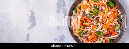 Asian salad with rice noodles, shrimp and vegetables, top view. Stock Photo