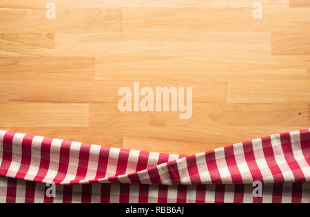 Red checkered fabric on wood table background.For decoration key visual layout Stock Photo