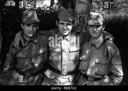 MOSCOW REGION, RUSSIA - CIRCA 1992: Portrait of soldiers of the Russian army. Three comrades. Film scan. Large grain. Stock Photo