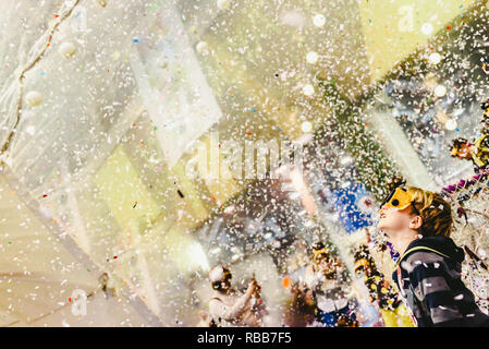 Boy enjoying a rain of confetti. Stock Photo