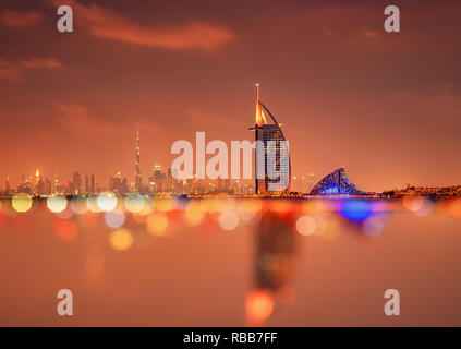 Burj Al Arab and Burj Khalifa in a beautiful panoramic skyline view at night in Dubai, UAE Stock Photo