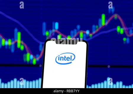 Intel logo is seen on an smartphone over stock chart Stock Photo