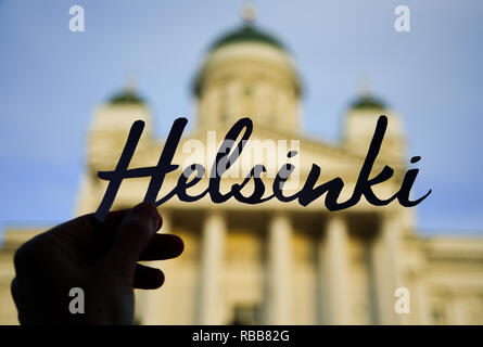 Word HELSINKI in hand with blurred Cathedral on background Stock Photo