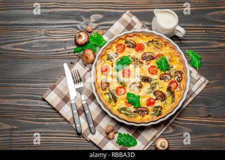 Baked homemade quiche pie in ceramic baking form Stock Photo
