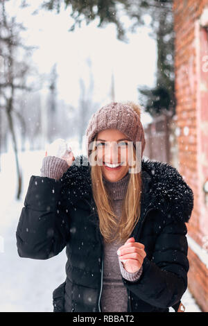 Woman throwing snowballs at Winter. Stock Photo