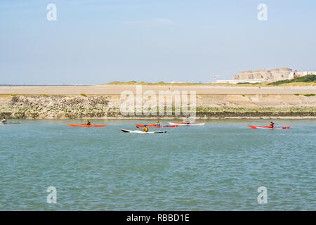 Grand-Fort-Philippe,FRANCE-July 18,2017: View of canoeists on the river, beach and background of the Gravelines nuclear power plant. Stock Photo