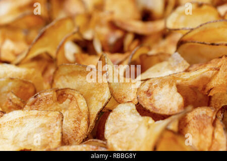 Potato chips fresh out of the fryer.  Macro shot.  Close up. Stock Photo
