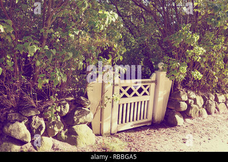 Vintage-style Little garden gate with undergrowth by jziprian Stock Photo