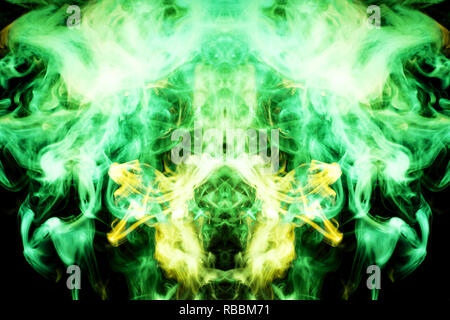 Thick colorful green  and yellow smoke  in the form of a butterfly on a black isolated background. Background from the smoke of vape. Mocap for cool t Stock Photo