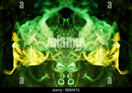 Thick colorful green  and yellow smoke  in the form of a butterfly on a black isolated background. Background from the smoke of vape. Mocap for cool t Stock Photo