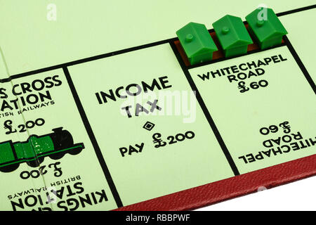 Close up detail of playing board for the game of Monopoly showing Income Tax Pay £200 Stock Photo