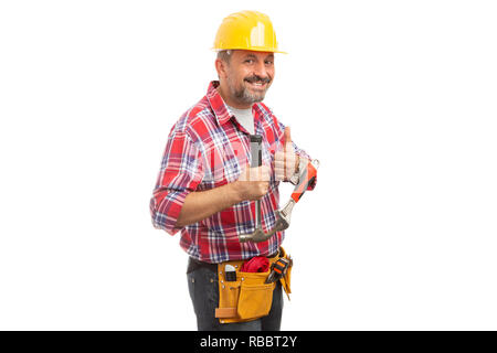 Friendly constructor showing thumb-up as like gesture and holding hammer and wrench isolated on white background Stock Photo
