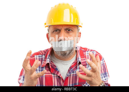 Builder with mouth shut by using grey duct tape making desperate gesture with hands close-up isolated on white background Stock Photo