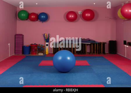 Gym with fitness balls and colorful flooring - Image Stock Photo