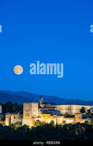 Moorish and Mudejar architecture of illuminated Alhambra palace and fortress at dusk, Granada, Andalusia, Spain Stock Photo