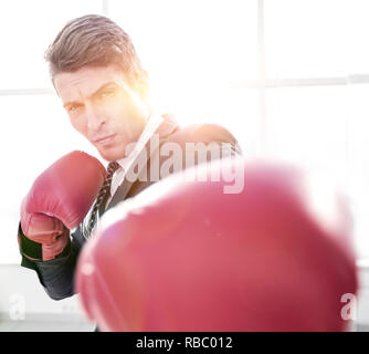 confident young businessman in Boxing gloves Stock Photo