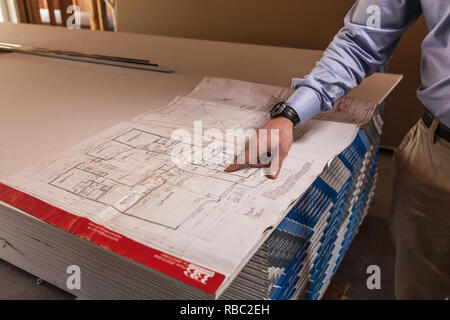 Man Pointing At Architectural Blueprint Stock Photo