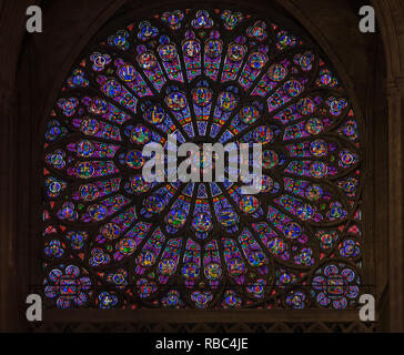 Paris, France - October 25, 2013: Closeup of stained glass of the oldest rose window in the Notre Dame de Paris Cathedral installed in 1225 Stock Photo