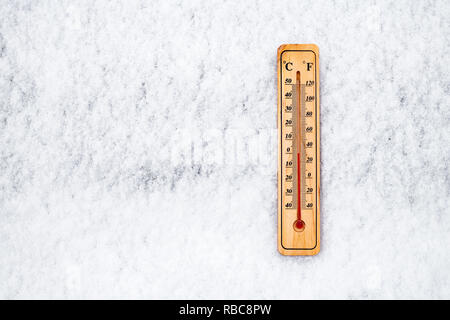 Thermometer in snow at zero degree on Celsius scale Stock Photo