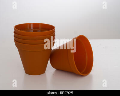 Stack of plastic flower pots on white background Stock Photo