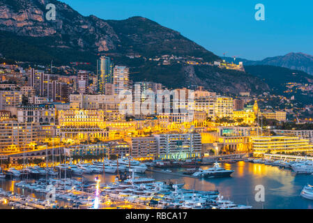 France, Provence-Alpes-Cote d'Azur, French Riviera, Alpes-Maritimes, Principality of Monaco. Monte Carlo illuminated at dusk. Stock Photo