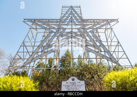 Roanoke, USA - April 18, 2018: City in Virginia during spring with Mill Mountain iconic star during sunny day, sign Stock Photo