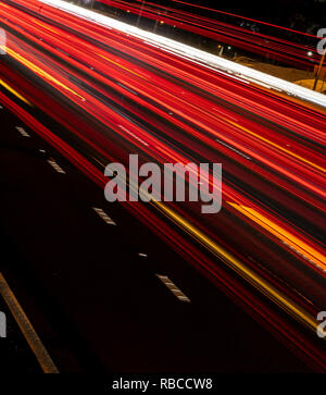 Light trail on a highway from the side of the road. vibrant light trails, vibrant colour Stock Photo