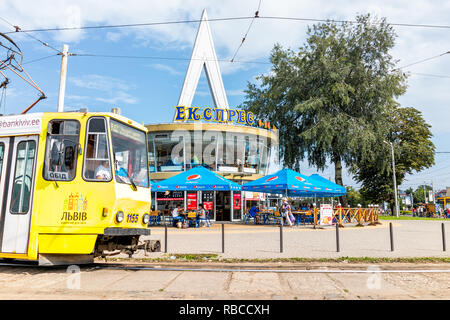 Lviv, Ukraine - July 30, 2018: Outside of Lvov train station building with trolley bus tram in historic Ukrainian city in summer, yellow and blue colo Stock Photo