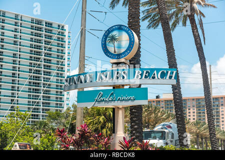 Sunny Isles Beach, USA - May 8, 2018: Sign for community city in North Miami, Florida, blue text on A1A Collins Avenue road street closeup Stock Photo