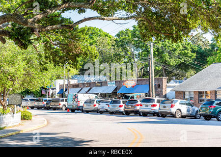 Mount Pleasant, USA - May 11, 2018: County of Charleston South Carolina area with oak trees and street road with restaurants stores shops and parking  Stock Photo